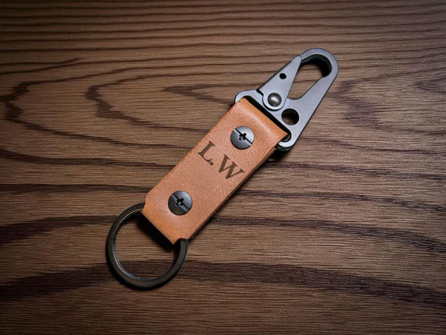 Brown Leather keychain with metal clip on a wooden surface