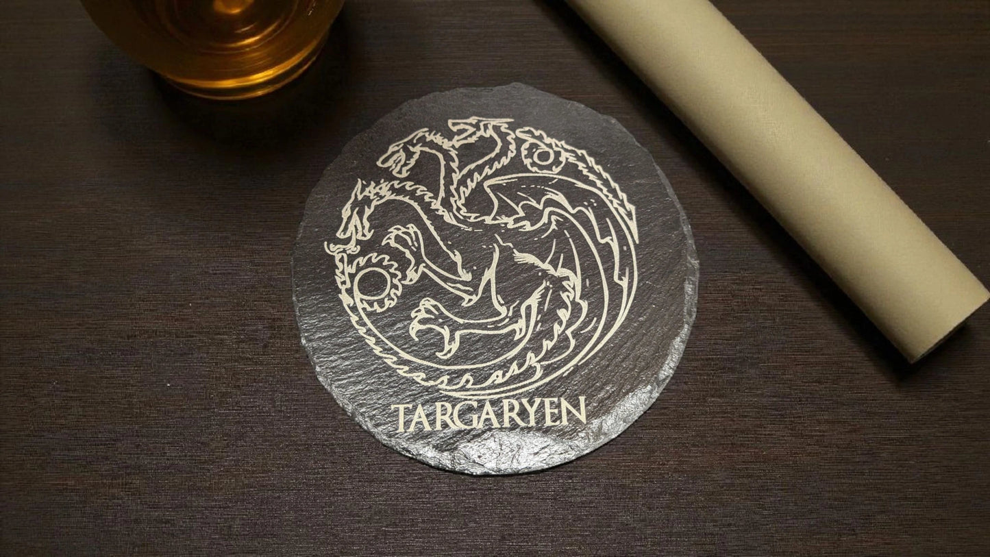 Slate coaster with Targaryen emblem on a wooden surface