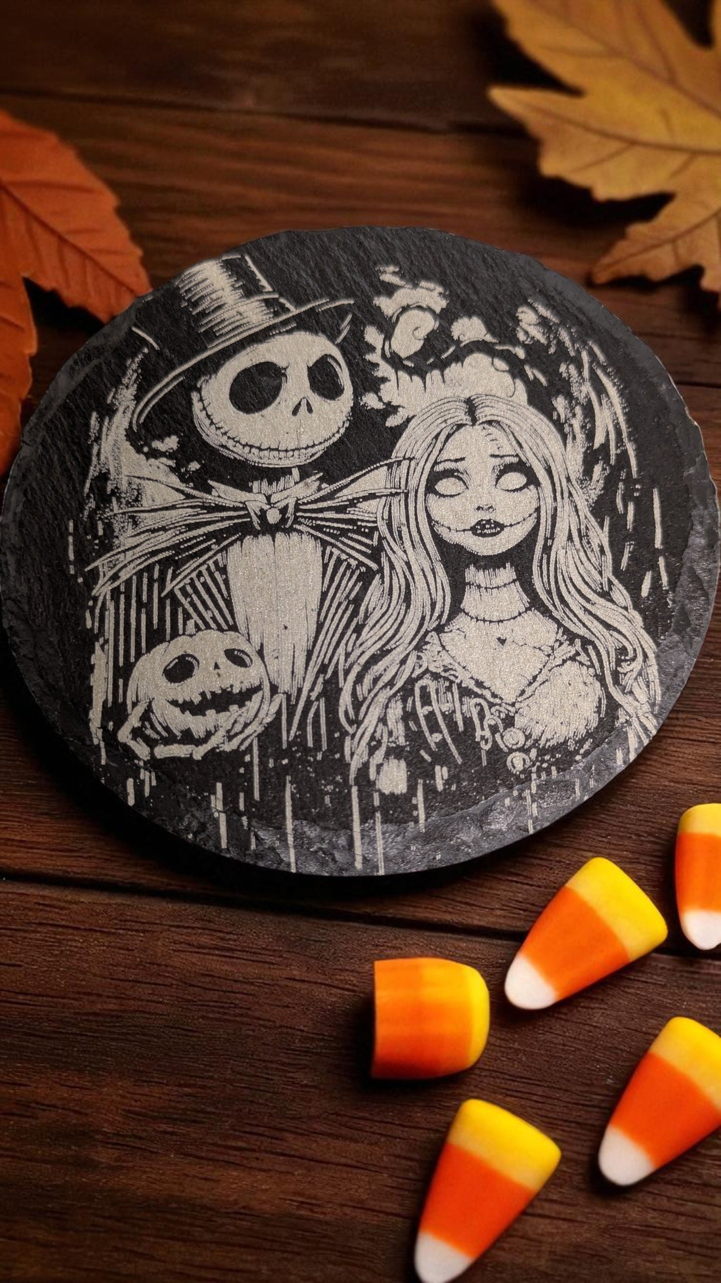 Decorative coaster with Halloween-themed design featuring a couple and pumpkins on a wooden surface with candy corn.