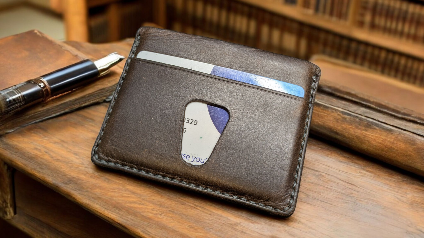 Solaris Brown leather wallet with a card on a wooden surface