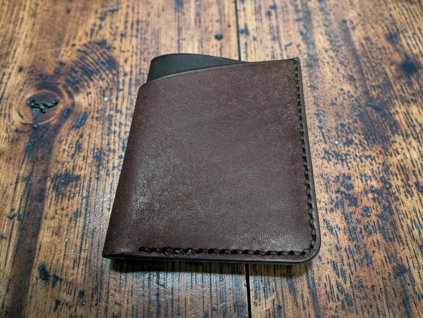 Brown leather kade card holder full grain leather wallet with visible stitching along the edges