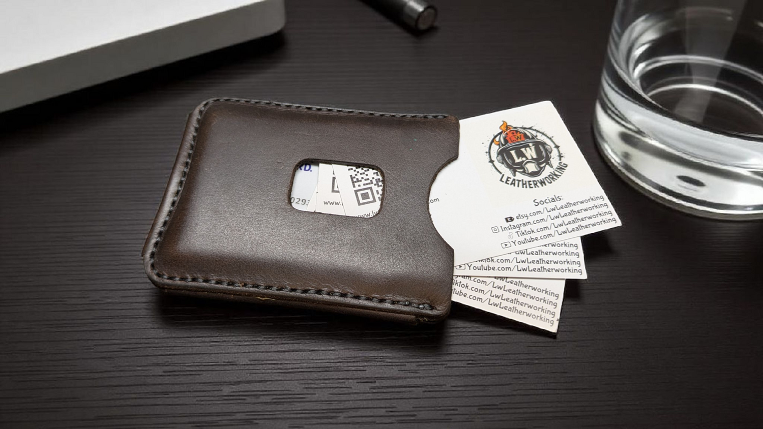 The 'Venturi' Wallet. A dark Brown minimalist Card holder wallet with a rich patina resting on an old rustic desk.