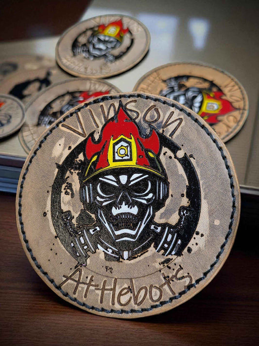 A closeup photo of a Bespoke Fire Service Velcro Shoulder Badge amongst a group of them.