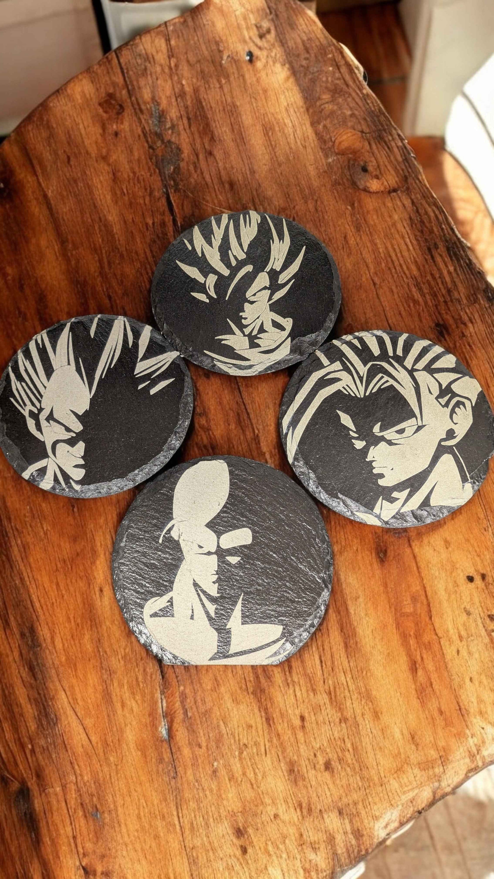 Dragonball Z Slate Coasters displayed on an oak table.