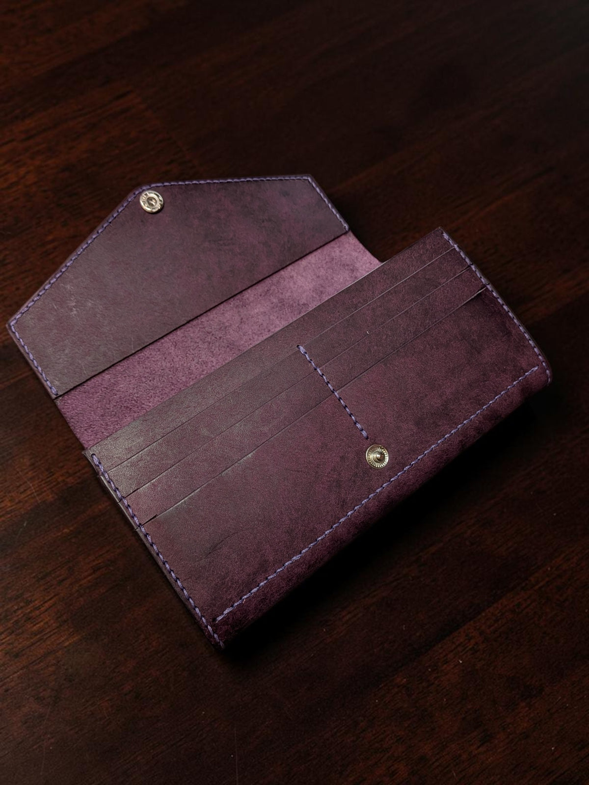 Purple leather ladies long wallet open showing six card slots and envelope flap with snap