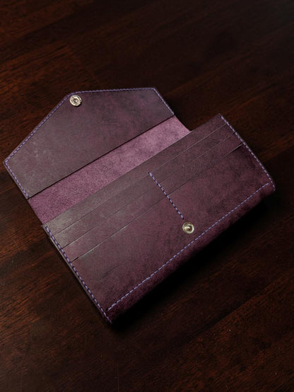 Purple leather ladies long wallet open showing six card slots and envelope flap with snap