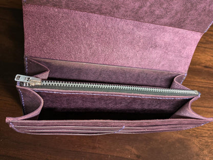 Inside the purple leather long wallet showing the zipped coin pouch and gusseted note compartments