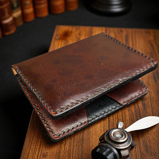 Brown leather wallet on a wooden surface with books and a lamp in the background
