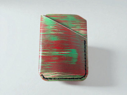Rectangular cardholder with red and green abstract pattern on a white background