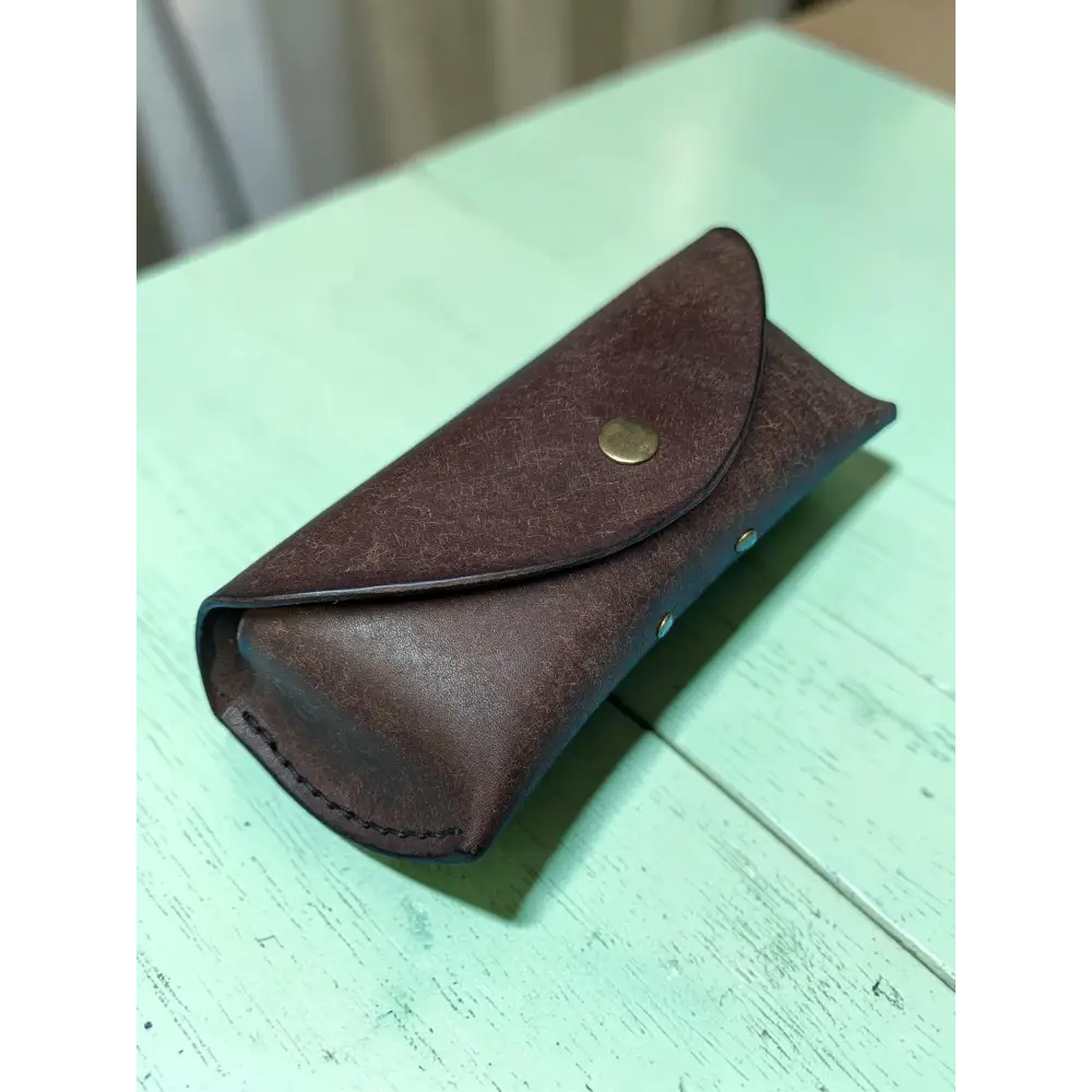 Brown leather Badalassi Pueblo sunglasses case with brass snap button and visible stitching handmade full grain leather