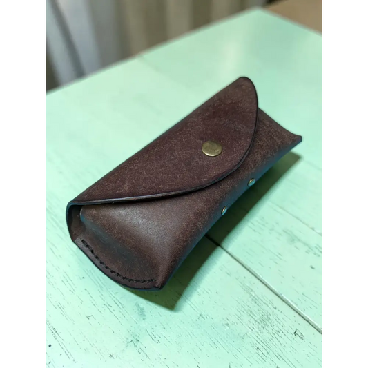 Brown leather Badalassi Pueblo sunglasses case with brass snap button and visible stitching handmade full grain leather