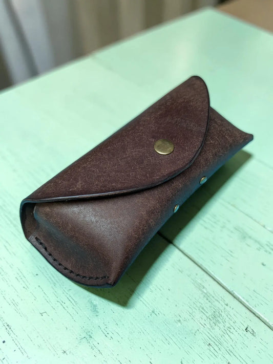 Brown leather Badalassi Pueblo sunglasses case with brass snap button and visible stitching handmade full grain leather