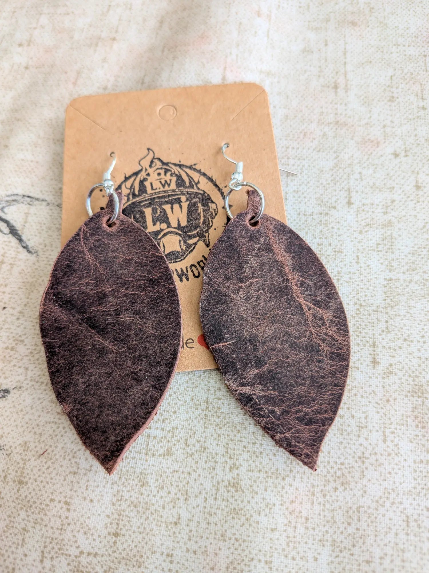Brown leaf pullup leather earrings featuring dark brown leaf-shaped design with silver-toned hooks