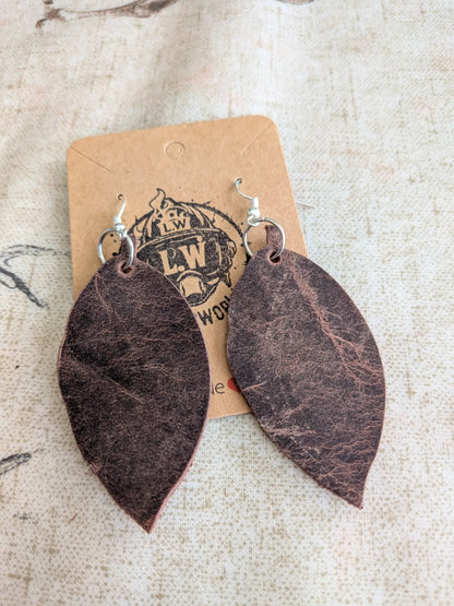 Dark brown leaf-shaped leather earrings with silver hooks made from brown leaf pullup leather