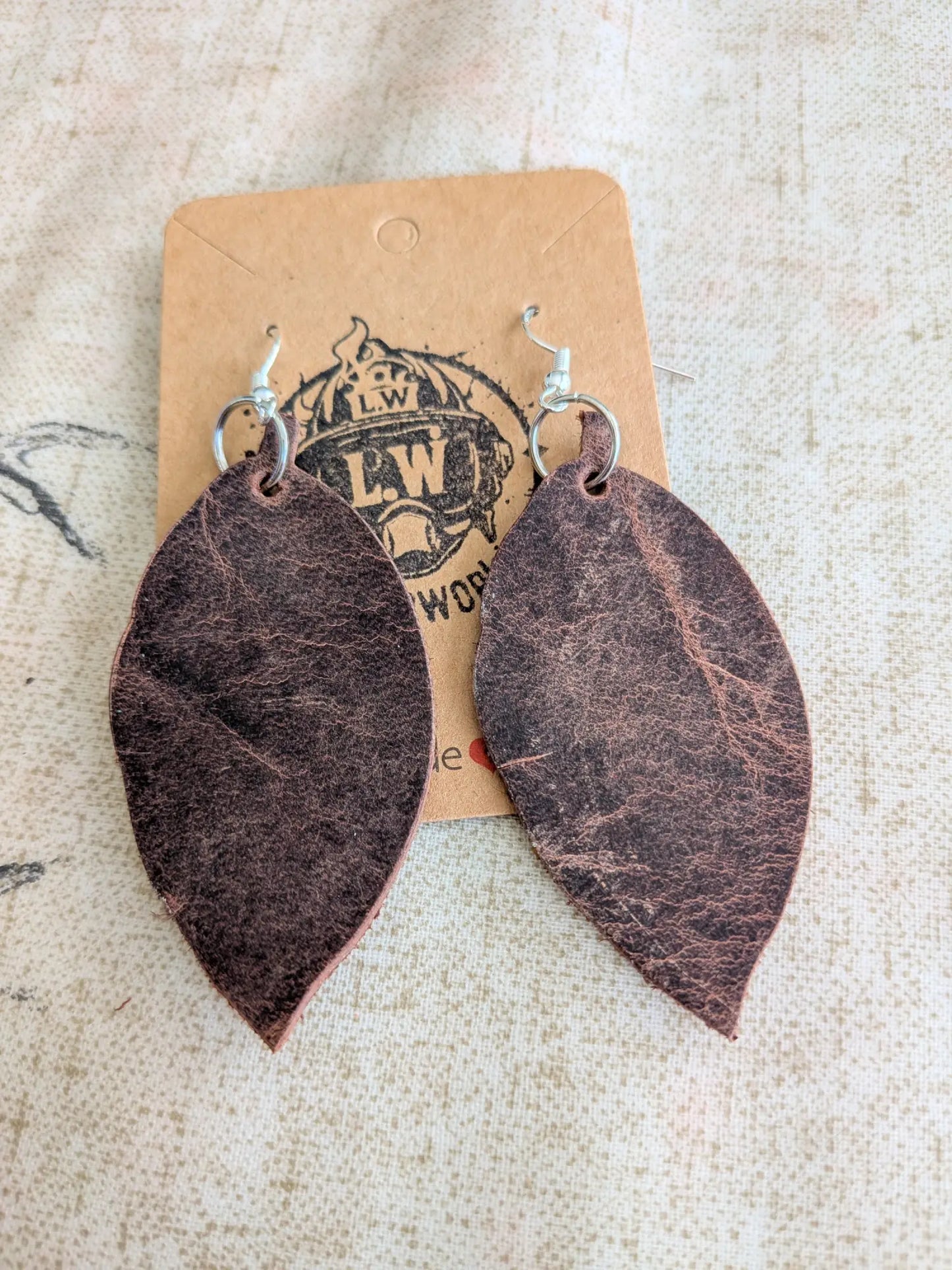 Dark brown leaf pullup leather earrings with subtle texture and silver-toned hooks for stylish wear
