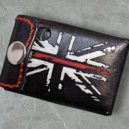 Black leather custom fire service alerter case with distressed union jack design and orange stitching on the back side