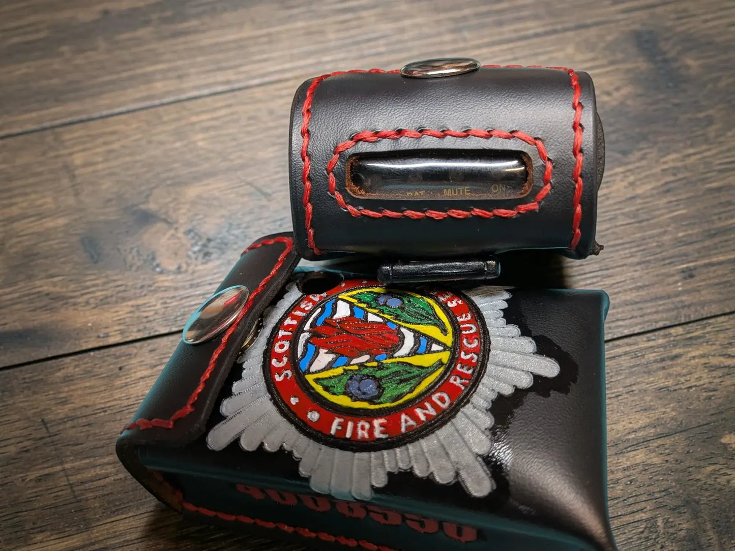 Black leather custom fire service alerter case with red stitching and scottish fire and rescue service emblem patch