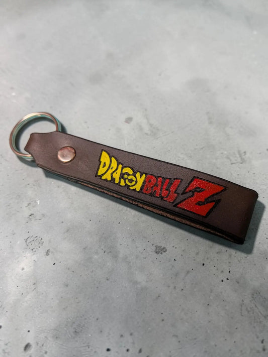 LwLeatherworking handmade brown full grain leather keychain with Dragon Ball Z logo in yellow and red.