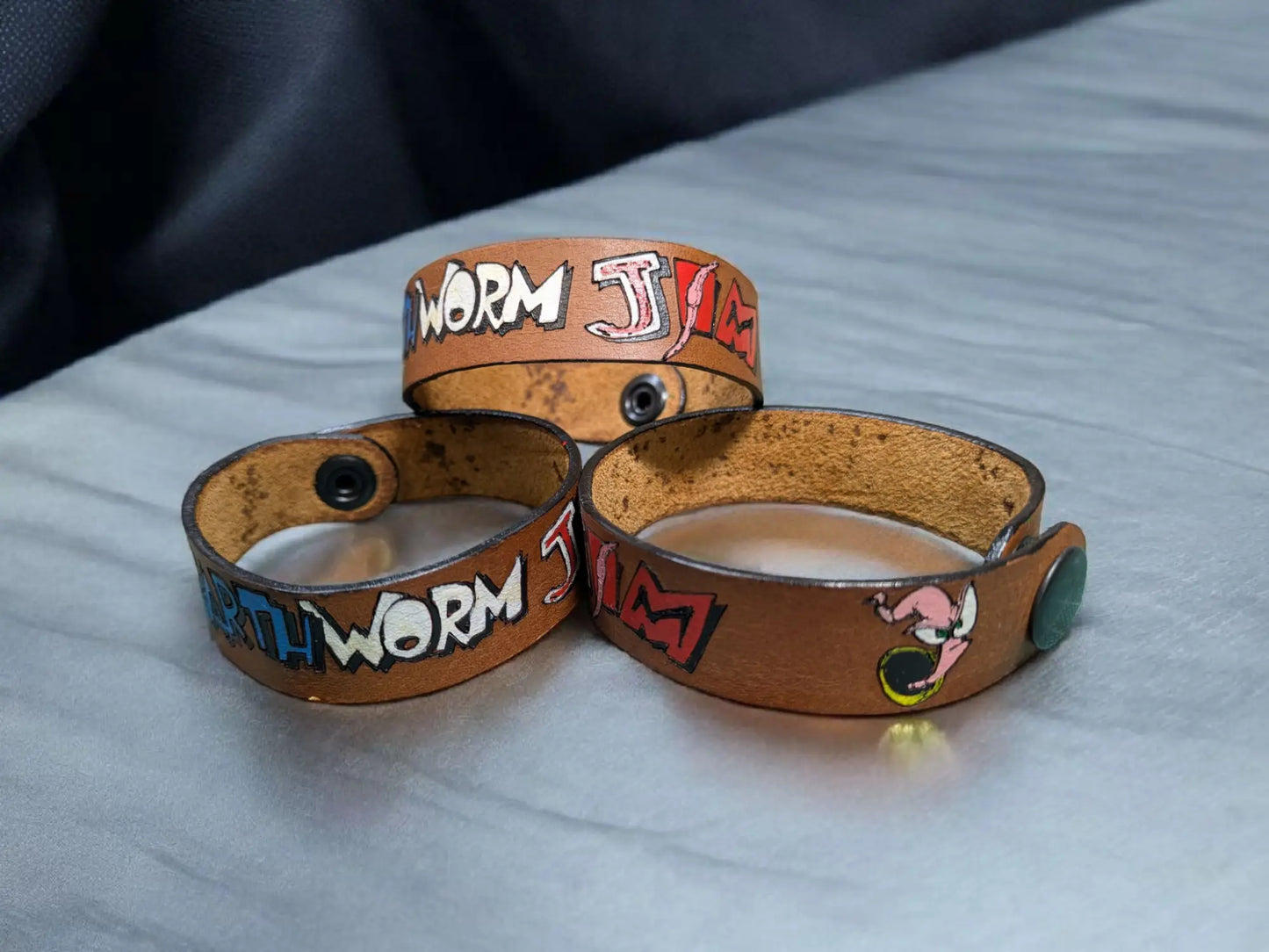 Earthworm jim inspired brown full grain leather wristband with hand-painted worm jam text and black snap closures
