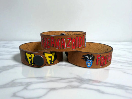 Brown leather wristbands with colorful freakazoid inspired leather painted lettering and character faces