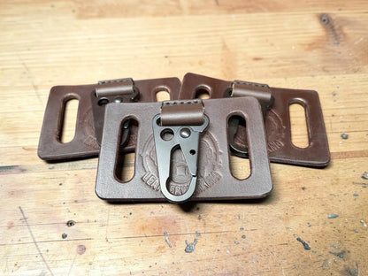 Brown full grain leather key holder with belt clip and metallic carabiner attachment for secure carrying