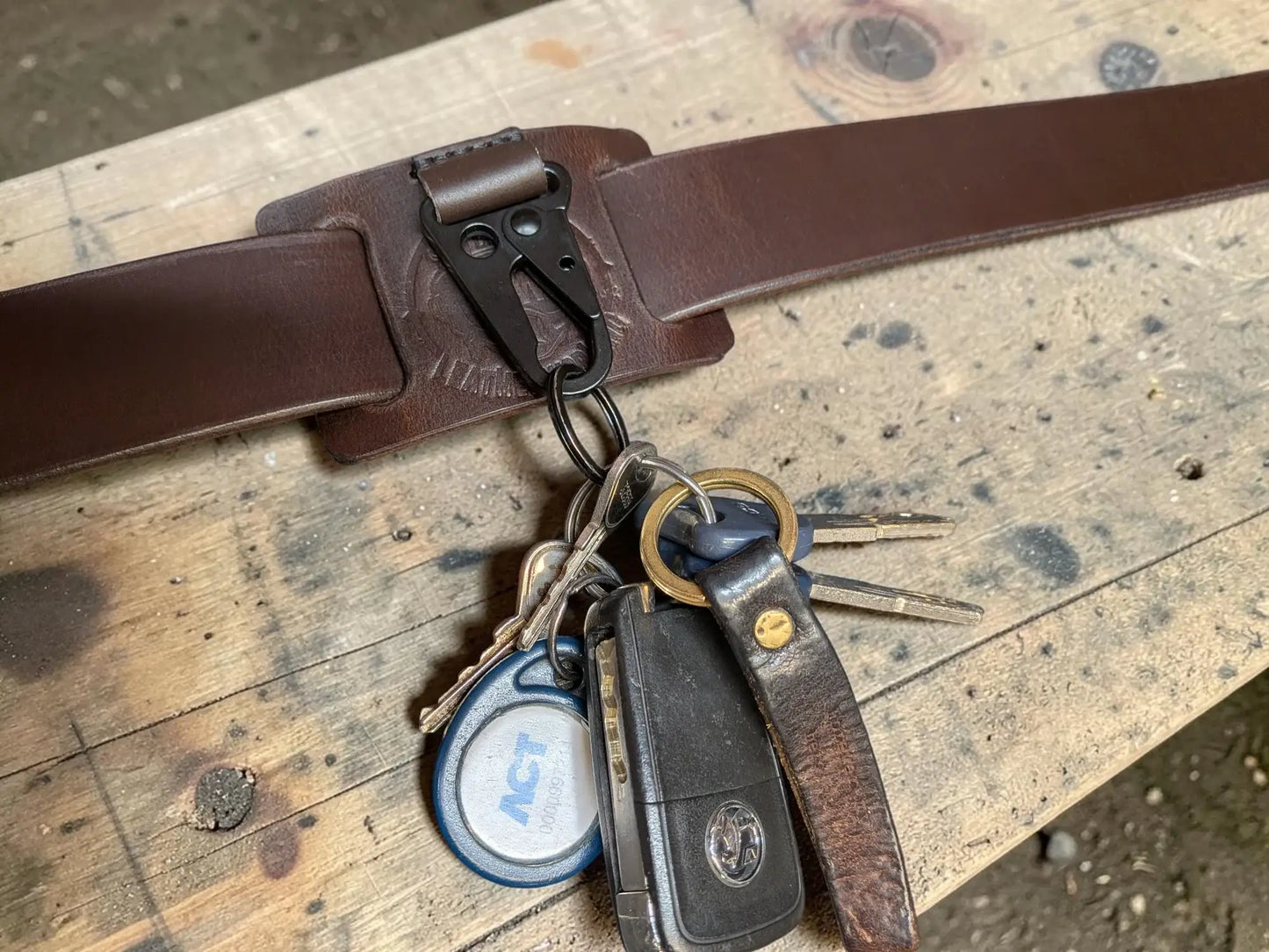 Brown full grain leather key holder with black metal clip and belt attachment for secure key carrying