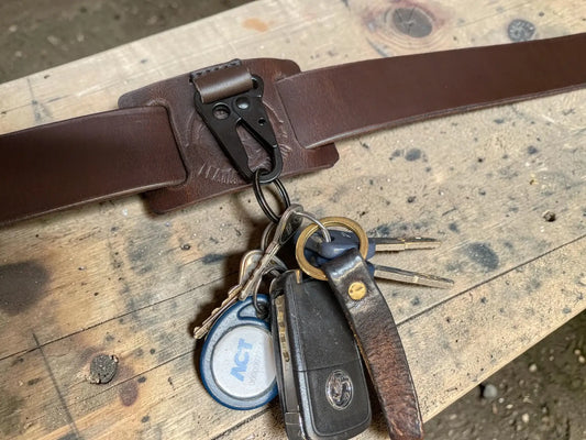 Brown full grain leather key holder with black metal clip and belt attachment for secure key carrying
