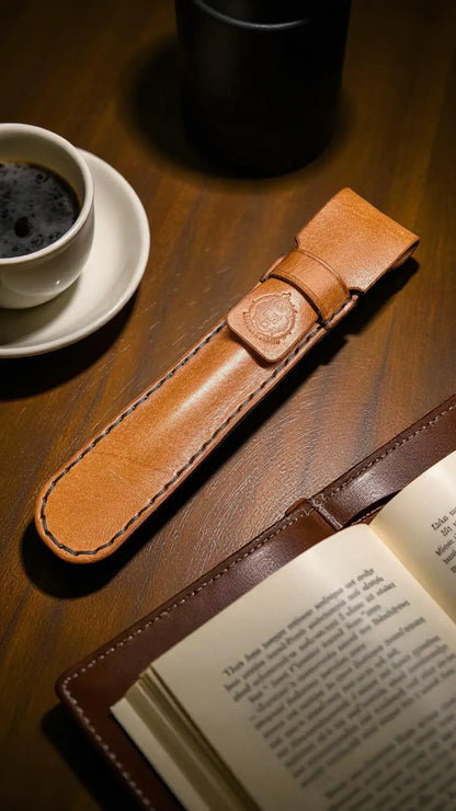 Brown leather Pen holder on a wooden table with a cup of coffee in the background