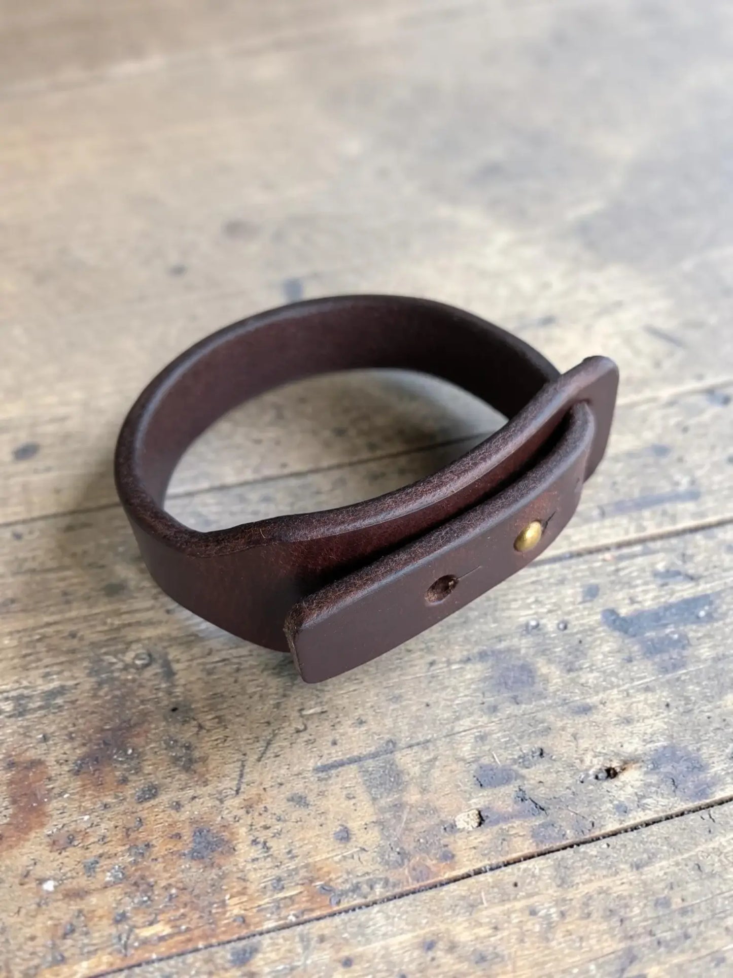 Dark brown full grain leather wrap bracelet with simple buckle and brass hardware for stylish wear