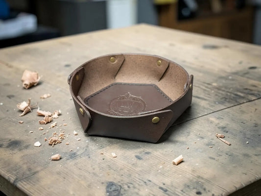 Handmade brown leather bowl with brass rivets and embossed logo made from vegetable-tanned full-grain leather