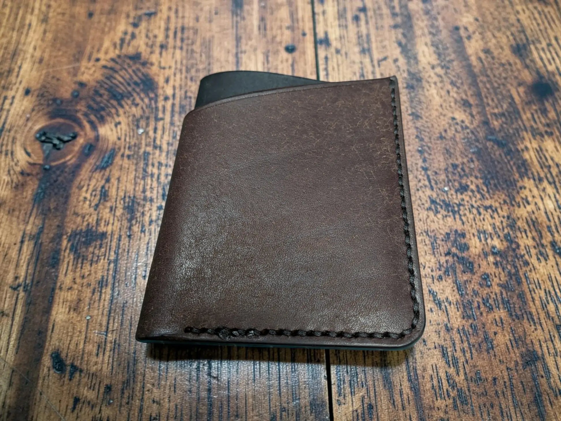 Brown leather kade card holder full grain leather wallet with visible stitching along the edges