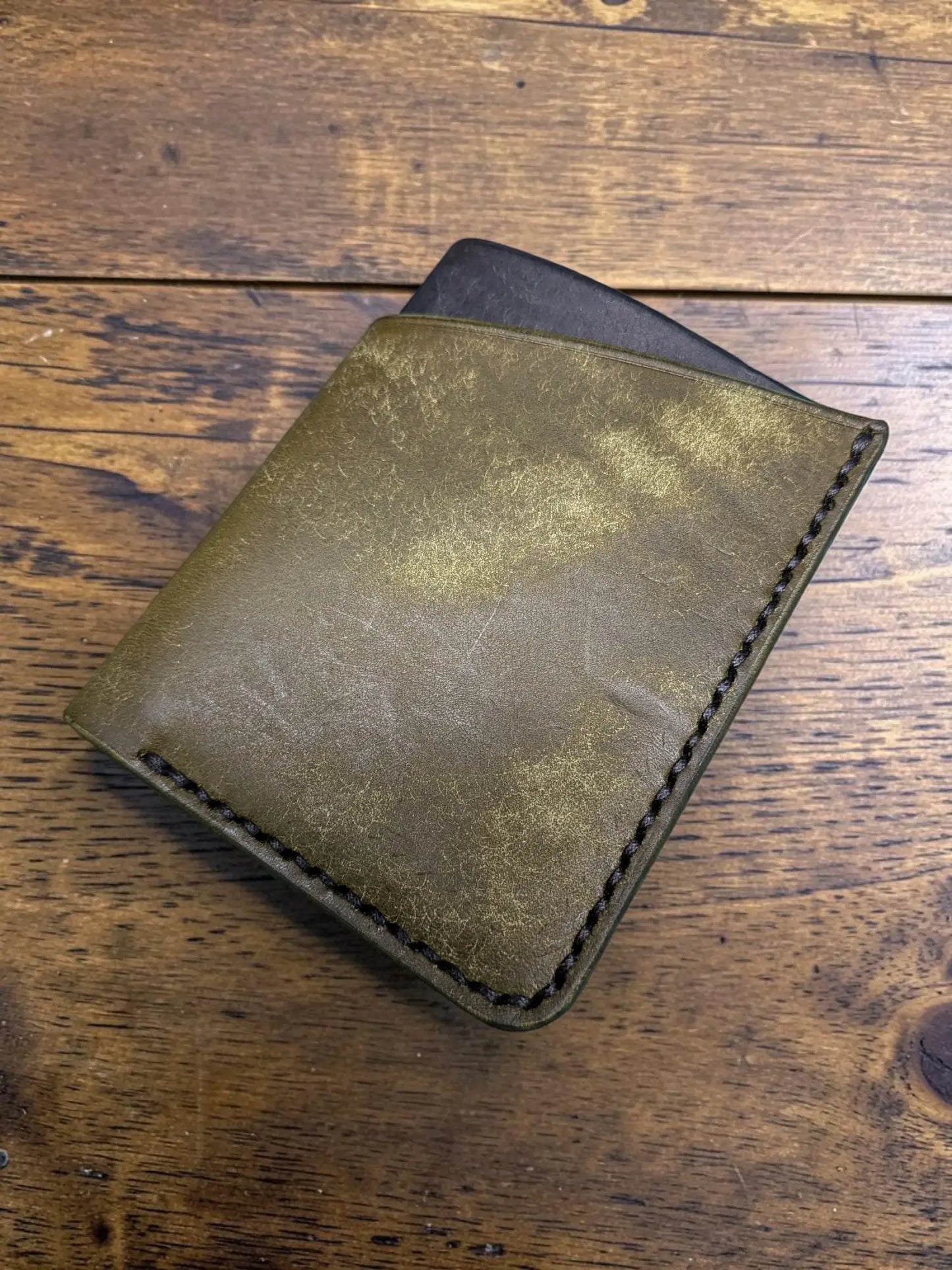 Olive green distressed full grain leather kade card holder wallet with black stitching and dark interior visible