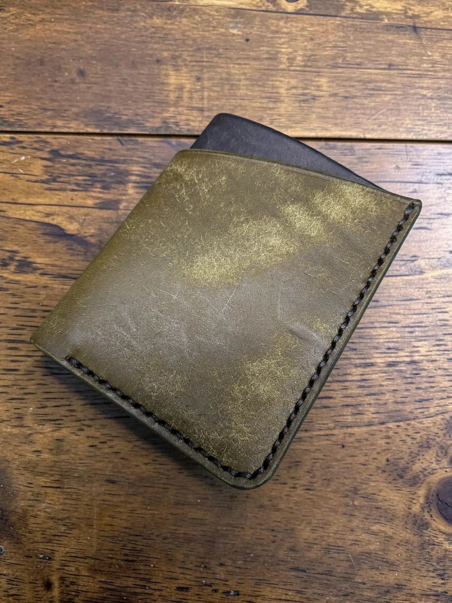 Olive green distressed full grain leather kade card holder wallet with black stitching and dark interior visible