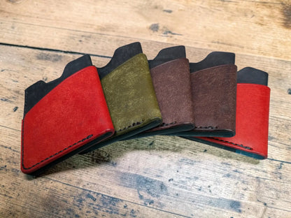 Set of five slim Kade card holder wallets in red olive green and brown full grain leather with black accents