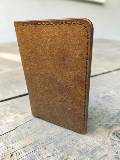 Tan leather passport cover with visible stitching edge details in badalassi pueblo leather passport holder design
